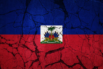 A cracked flag of Haiti. Devastation caused by major earthquake.