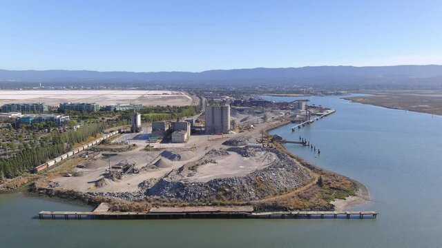 Aerial Orbit Around Cement Plant on the Water