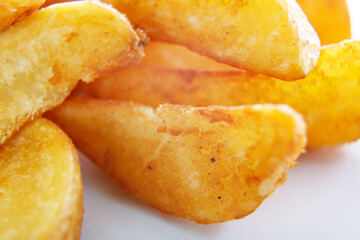 Fried potatoes close-up on a white background