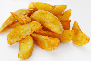 Roast potatoes seasoned with salt on white background
