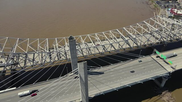 Traffic on Highway Bridges Above Ohio River, Louisville, Kentucky, USA on Sunny Day. Abraham Lincoln and John F. Kennedy Memorial Bridge, Drone Shot 60fps