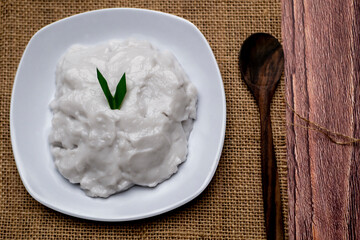 Bubur sumsum, Indonesian Traditional Food, rice porridge with palm sugar and pandan leaf with wooden spoon