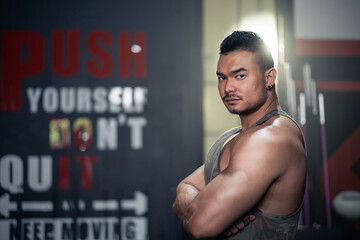 Portrait of Asian Bodybuilder workout exercise for healthcare at gym. 