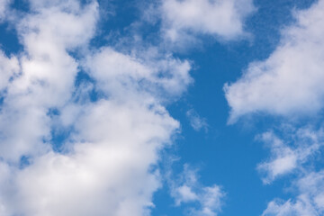 Beautiful blue panorama with fluffy cumulus clouds in the blue sky. Perfect background of blue sky and white clouds for your photos, mockup for design, use for sky replacement