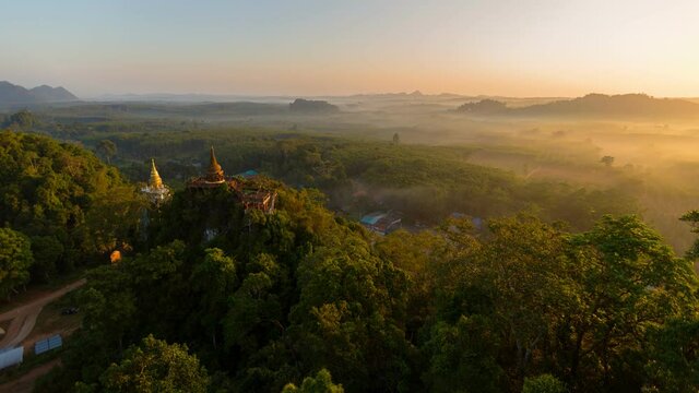 Time lapse Aerial view of Khao Na Nai pagoda stupa. Luang Dharma Temple Park with green mountain hills and forest trees, Surat Thani, Thailand. Thai buddhist temple archtecture. Tourist attraction