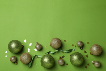 Baubles, stars and ribbon on green background
