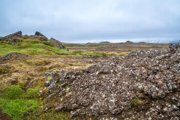 Iceland landscape with broken old lava hill and desert valley way to volcano 