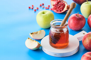Rosh hashanah jewish New Year holiday concept. Apples, honey, pomegranate