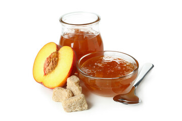 Jar and bowl of peach jam, ingredients and spoon isolated on white background