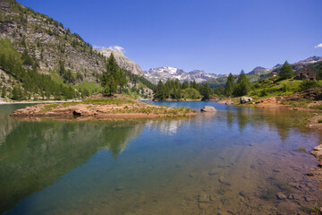 Fototapeta na wymiar View of idyllic alpine lake with clear water in the summer season, Val Devero, Piedmont, Italy