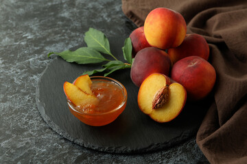 Peach jam and ingredients on black smokey table