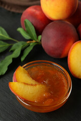 Bowl of peach jam and ingredients, close up