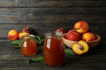 Peach jam and ingredients on rustic wooden table