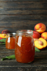 Peach jam and ingredients on rustic wooden table