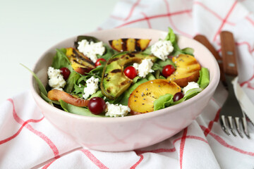 Concept of tasty salad with grilled peach, close up
