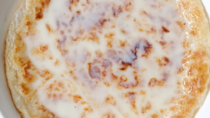 Chapati a thin pancake known as roti topping with sweet condense milk, Indian traditional street food.