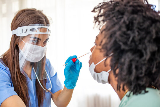 Doctor wearing personal protective equipment performing a Coronavirus COVID-19 PCR test, patient nasal NP and oral OP swab sample specimen collection process, viral rt-PCR DNA diagnostic procedure - Powered by Adobe