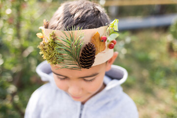 boy wearing a crown made of natural materials, late summer or autumn crafts
