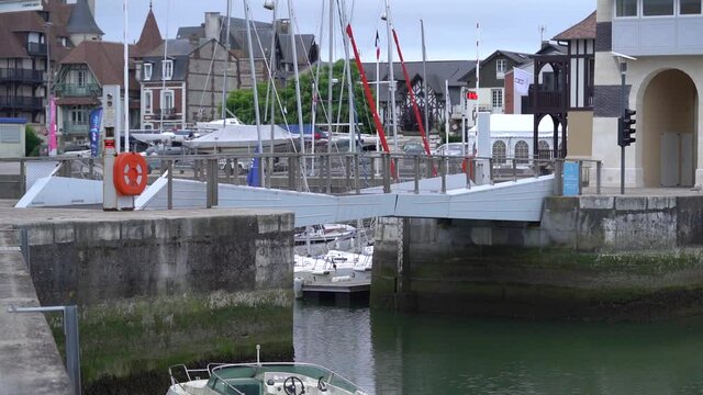 A drawbridge leading from Deauville to Trouville in Normandy Northern France at low tide, static shot

