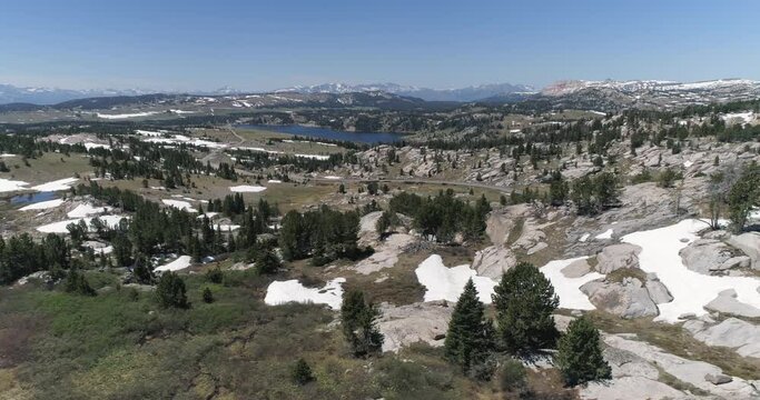 Aerial view of scenic mountains and  Beartooth Highway in Wyoming near Yellowstone National Park. Rocks partially cover with snow on the border of Montana and Wyoming