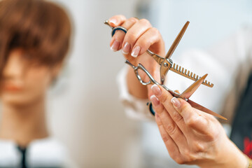 Hand of a Hairdresser Holding Hairdressing Scissors, Explaining Haircutting Techniques to Students