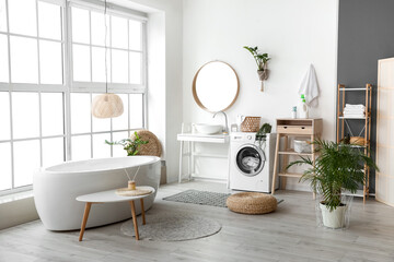 Interior of bathroom with modern washing machine