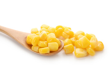 Wooden spoon of corn kernels on white background