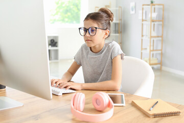 Cute little programmer using computer in office