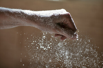 The initial step in making cookies is to sift the flour by hand