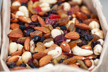 Assorted nuts in paper boxes for sale in the market.