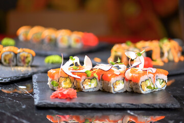 Philadelphia Maki Sushi set with salmon, passion fruit sauce and coconut chips on top. Sushi menu. Japanese food.