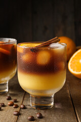 Glasses of tasty coffee with orange juice on table