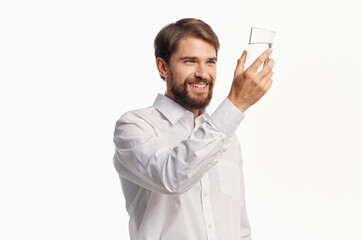 man in white shirt drinking water light background