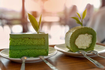 Close up of two pieces fresh green tea cake on white plate