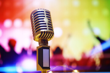 Retro style microphone on background backlight. Vintage Microphone for sound, music, karaoke. Speech broadcast equipment. Live pop, rock musical performance. Selective focus