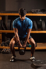 Obraz na płótnie Canvas black latino man works out at the gym