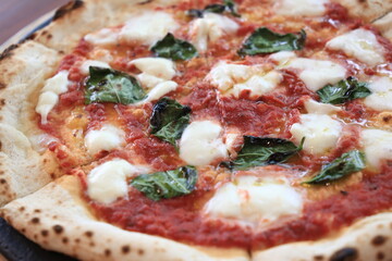 Italian traditional Margherita pizza cooked in a oven.