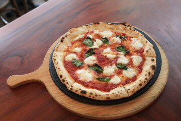 Italian traditional Margherita pizza cooked in a oven.