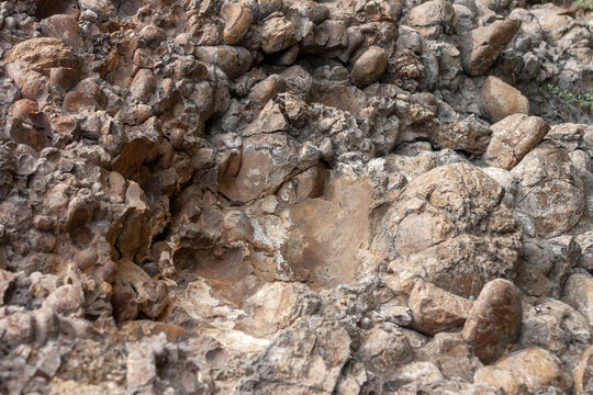 Background texture of rock with empty hollows from the fallen stones. Horizontal image.