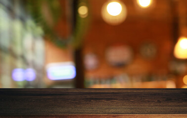 Empty wooden table in front of abstract blurred background of coffee shop . can be used for display or montage your products.Mock up for display of product