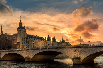 Paris, France - March 14, 2021: Beautiful sunset on the Seine river with Conciergerie monument in background in Paris