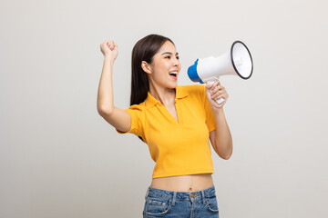 Shout out loud with megaphone. Young beautiful asian woman woman announces with a voice about...