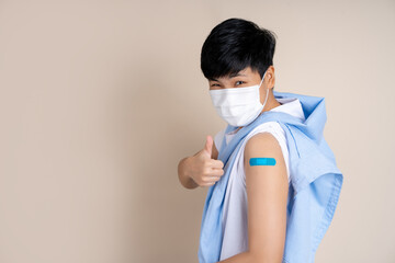 Campaign vaccination safe life happy smile cheerful. Asian people wearing a mask and showing shoulder with blue bandage,  Received Vaccine Concept.