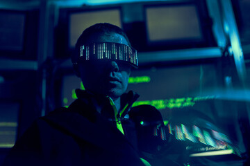 Cyber hacker breaks into databases to obtain information using a computer.