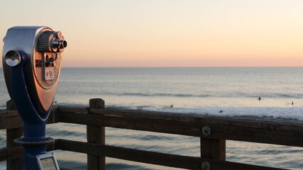 Metallic stationary observation tower viewer, waterfront old binoculars, Oceanside pier, California...