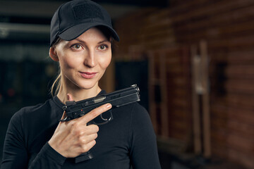 Focused female shooter mastering a one-handed handgun grip