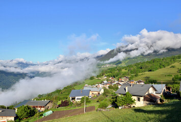  alpine village in a hill under cloudy sky in europe