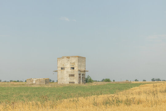 An unfinished abandoned house in a field