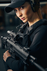 Female shooter in a cap looking ahead