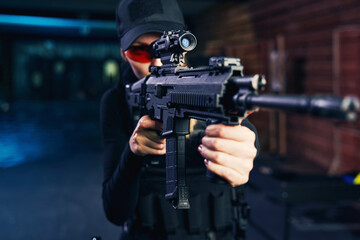 Concentrated young Caucasian sniper firing a weapon